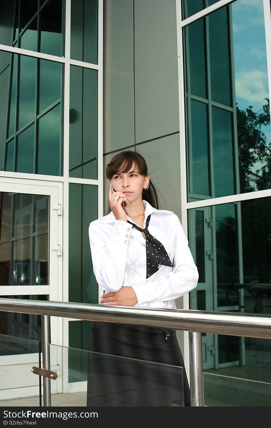 Businesswoman calling by phone outdoors