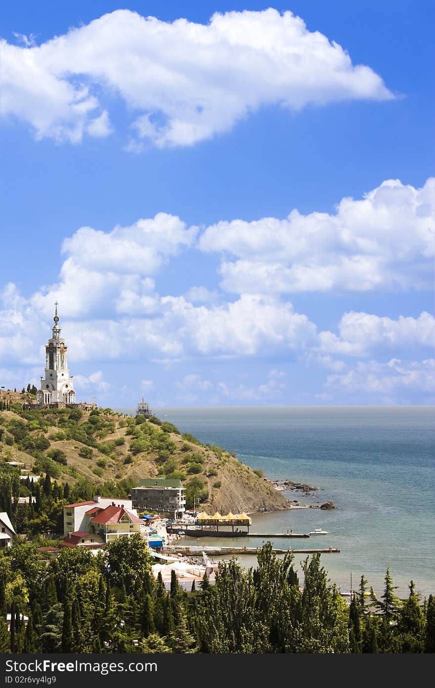 Photo of a crimea coastline with a church on a mountain in malorechenskoe