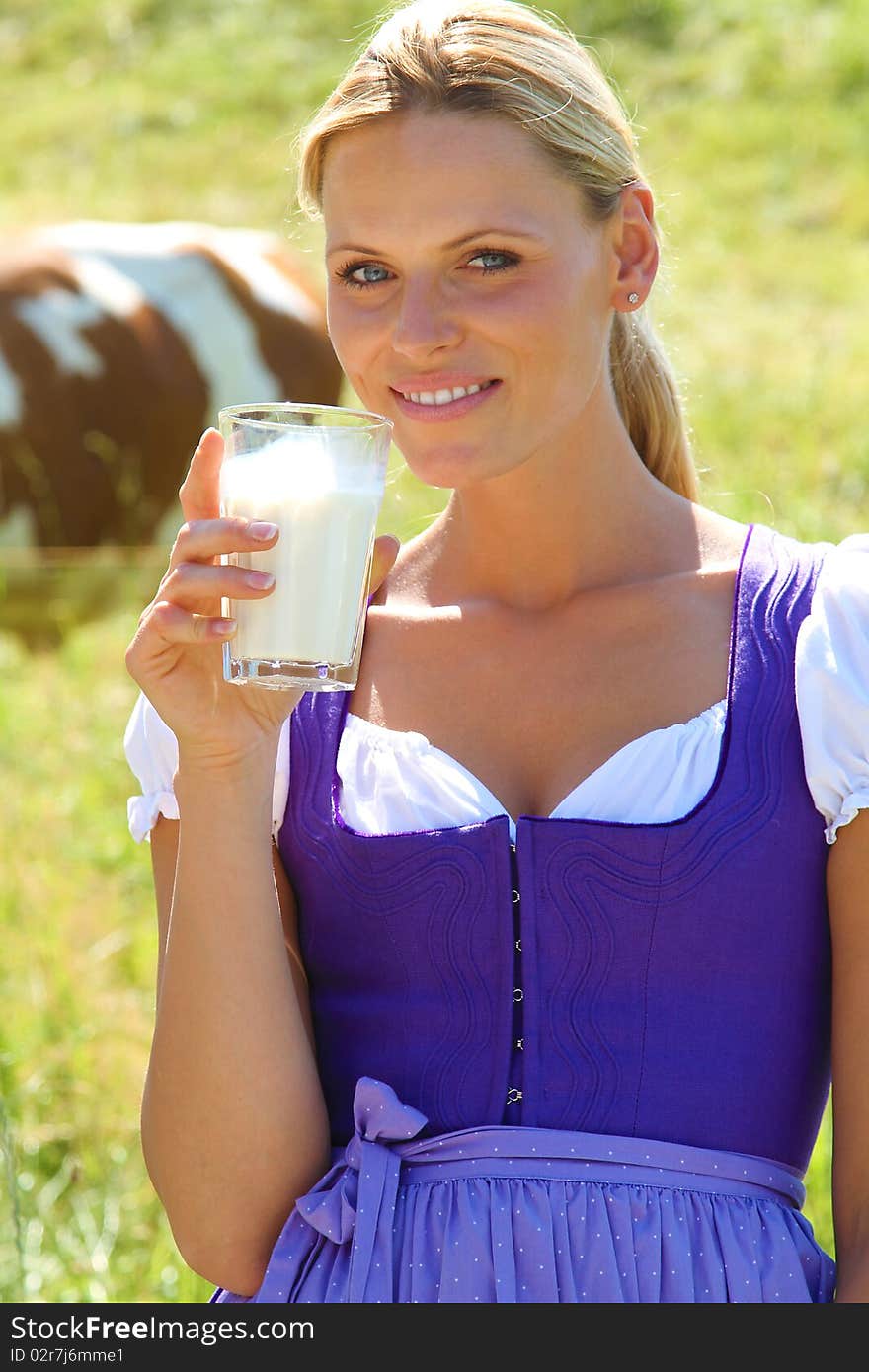 Blond bavarian Girl drinking a glas of milk. Blond bavarian Girl drinking a glas of milk