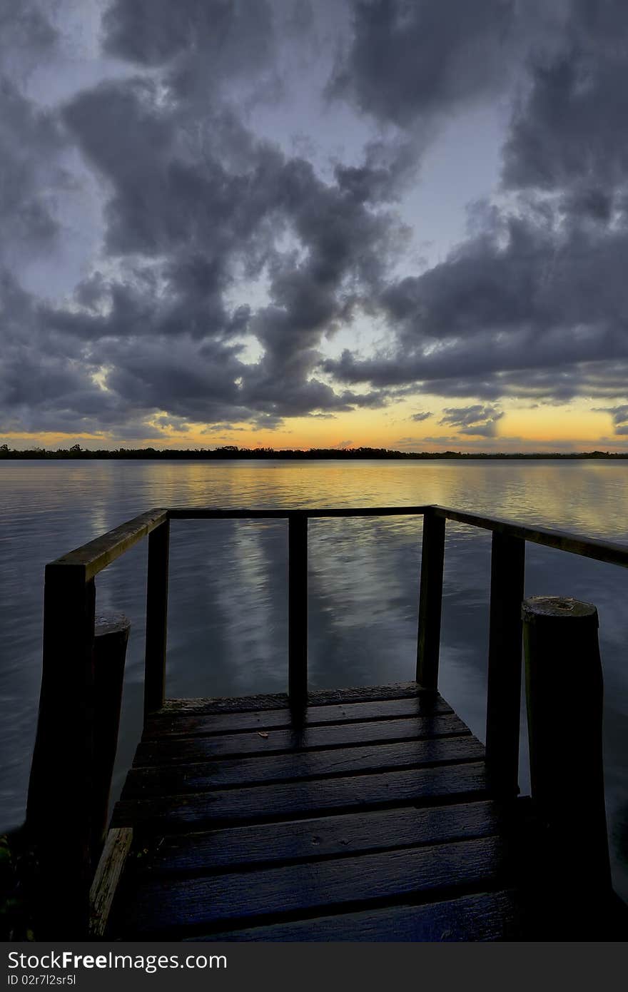 View of a lakeside pier at dusk. High dynamic range processing. View of a lakeside pier at dusk. High dynamic range processing.