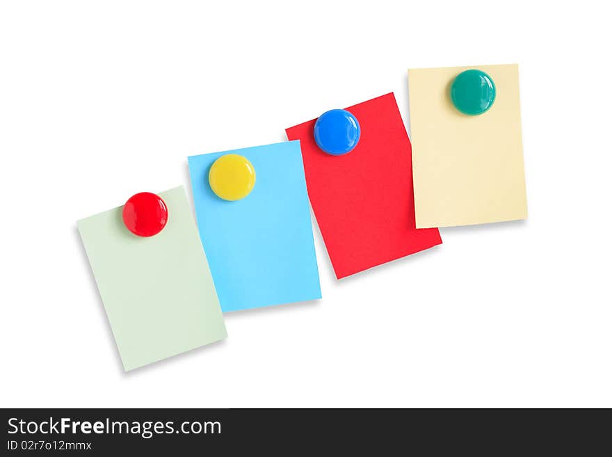 Few colored paper sheets hanging with magnets on white background. Clipping path included. Few colored paper sheets hanging with magnets on white background. Clipping path included