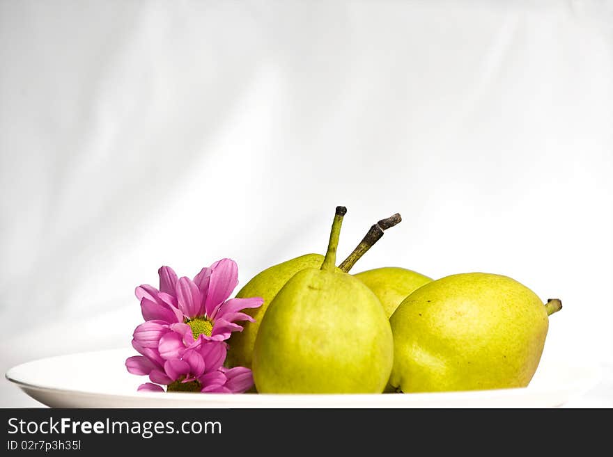 3 green pear and flower on plate