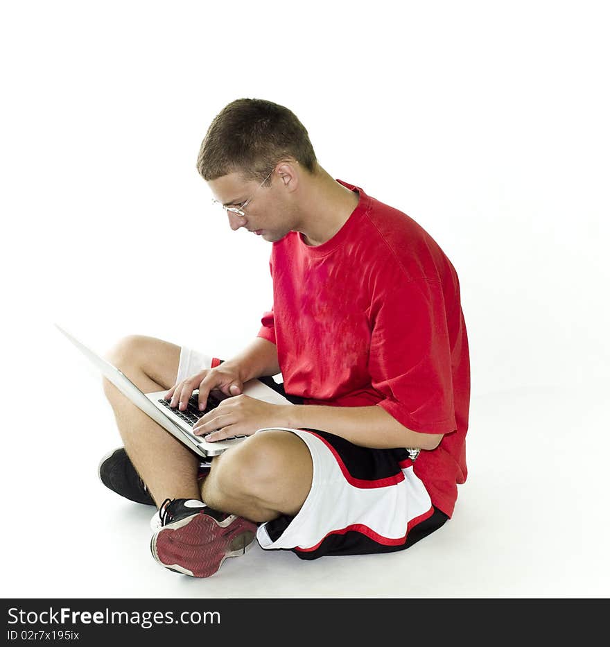 Young man, teenager with red shirt working on laptop, isolated on white background. Young man, teenager with red shirt working on laptop, isolated on white background