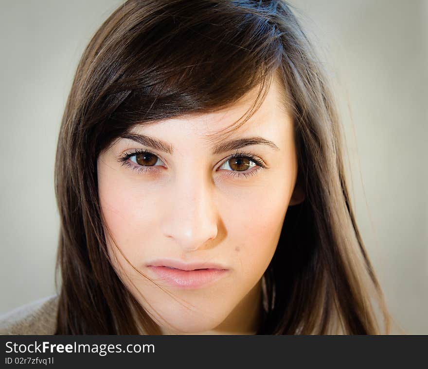 A pretty young woman stares seductively and directly into the camera.