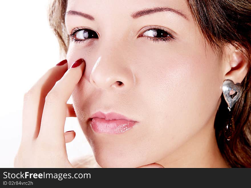 Woman looking at the camera with hands on face. Woman looking at the camera with hands on face