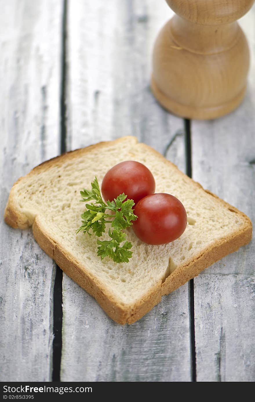 Aranged food two tomatoe on toast, on wooden background