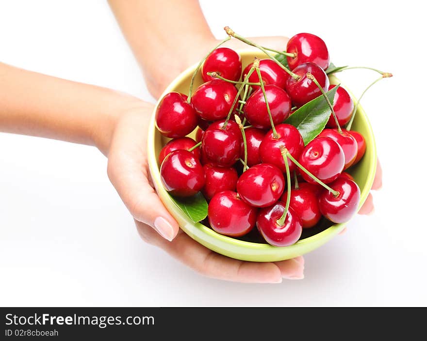 Crockery with cherries in woman hands.