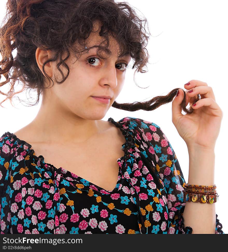 Portrait of a girl playing with her curly hair isolated on white