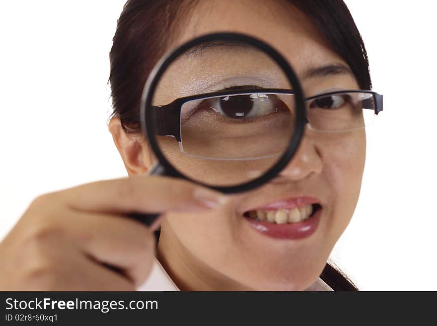 An Asian woman using a magnifying glass. An Asian woman using a magnifying glass