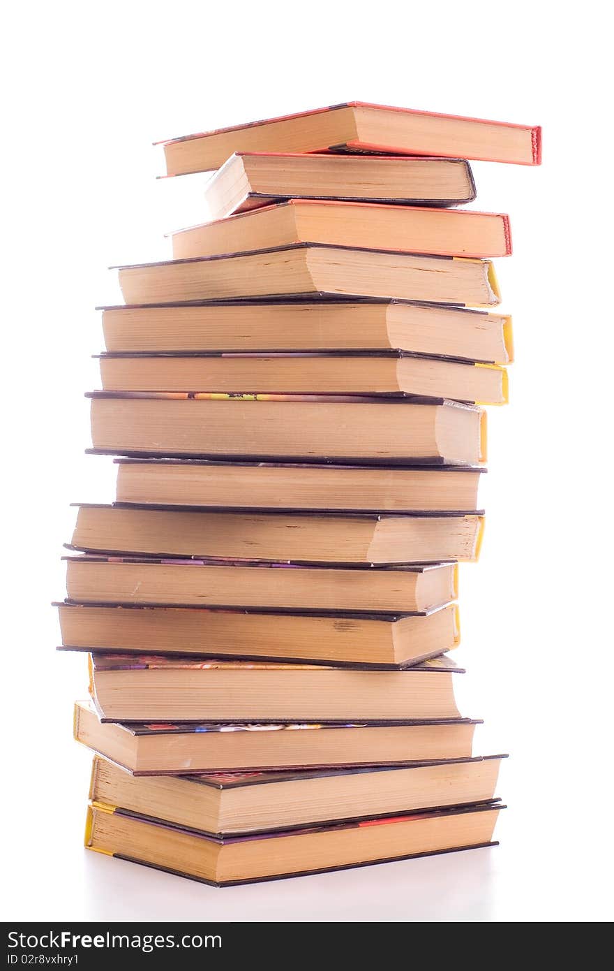 A pile of battered old books on white background