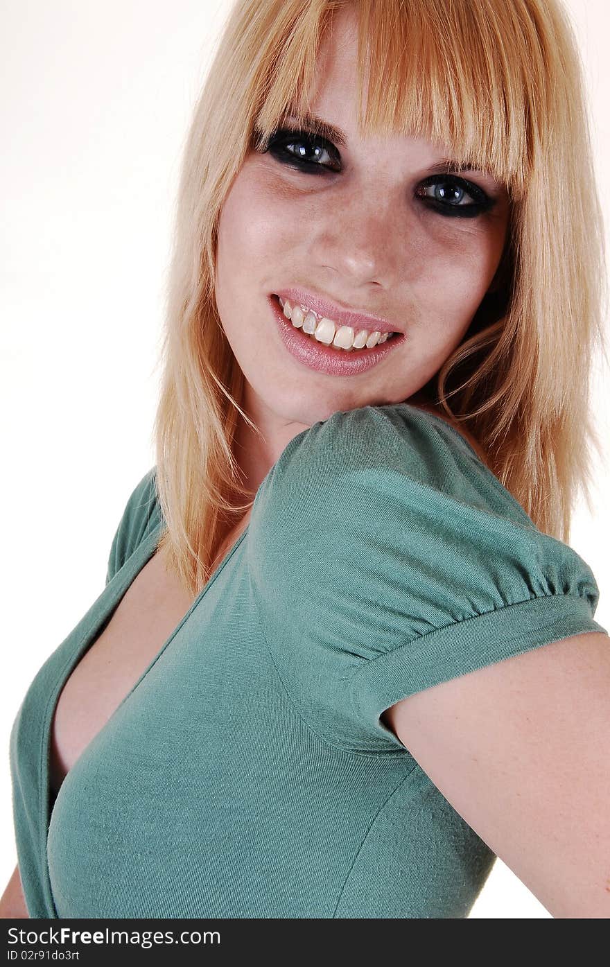 An closeup portrait of a young blond woman in a green sweater, smiling
into the camera, on white background. An closeup portrait of a young blond woman in a green sweater, smiling
into the camera, on white background.