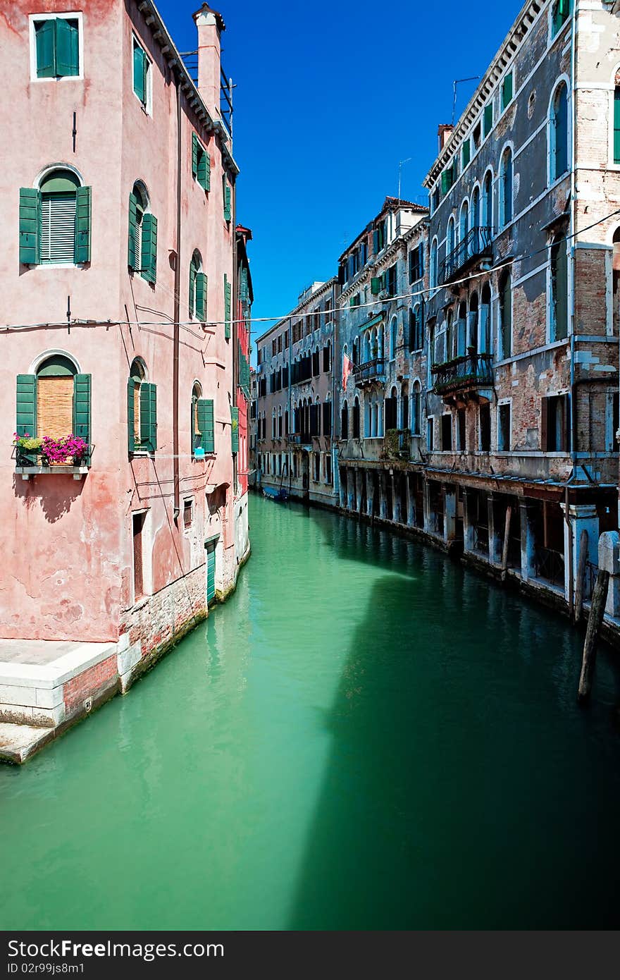 View of beautiful colored venice canal with houses standing in water