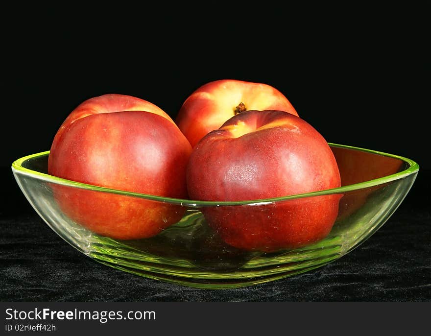 Three Large Ripe Nectarine In A Vase