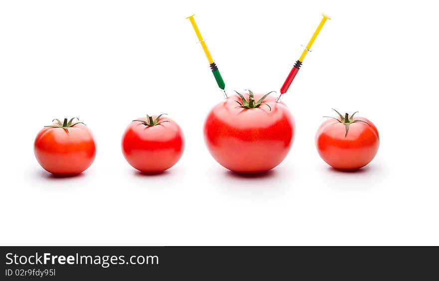 Injecting liquid in big tomato. Useful for genetic modification concepts. Injecting liquid in big tomato. Useful for genetic modification concepts.