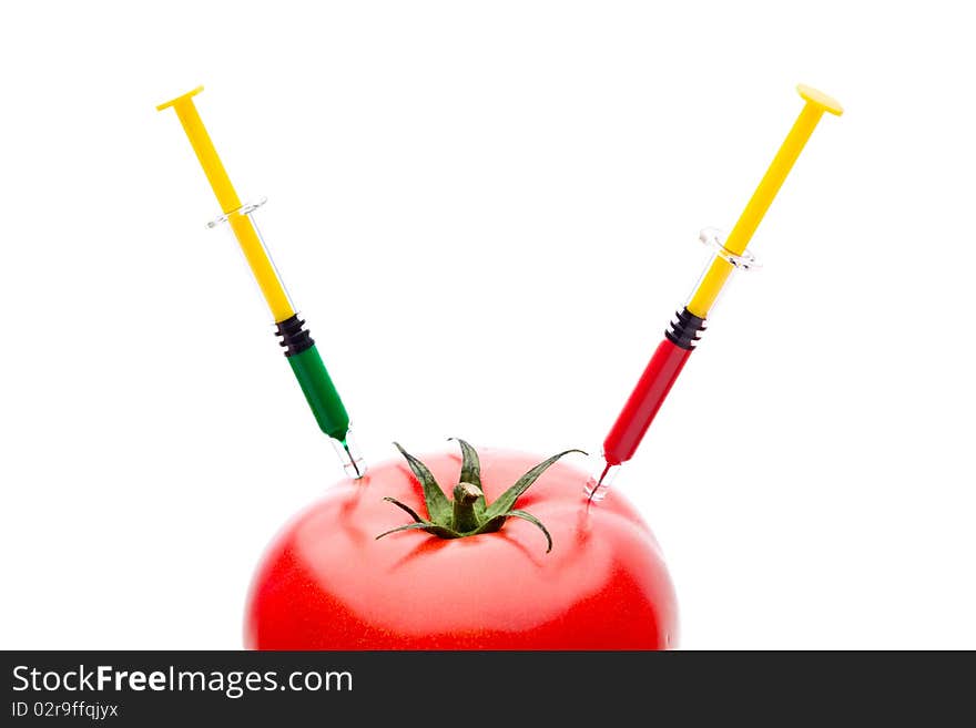 Syringe Injecting Red Green Liquid Into Tomato