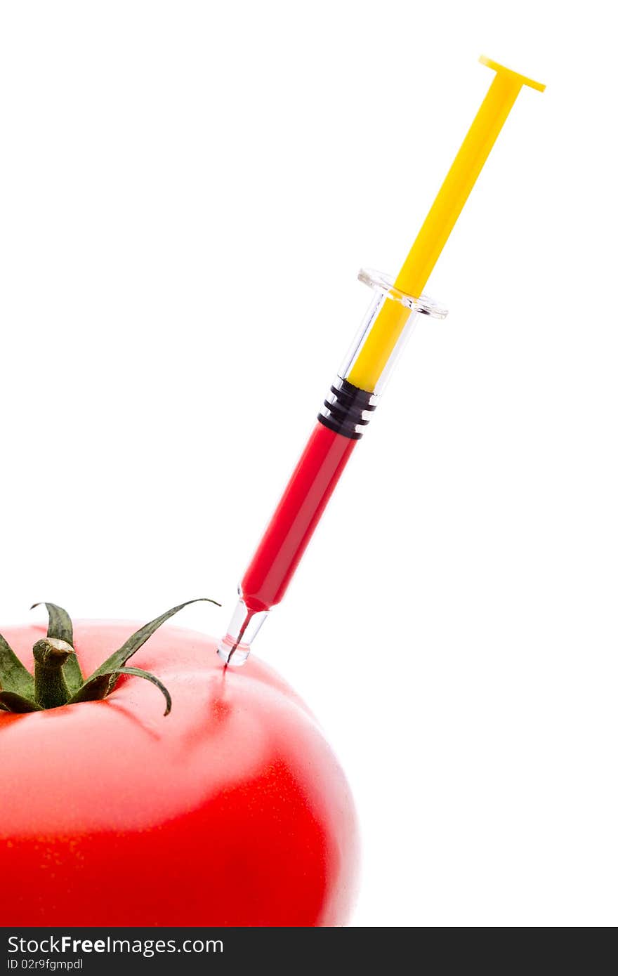 Injecting red liquid in big tomato. Useful for genetic modification concepts. Injecting red liquid in big tomato. Useful for genetic modification concepts.