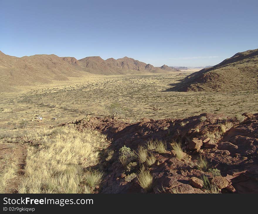 Rocks in a desert with some bush. African landscape. Rocks in a desert with some bush. African landscape