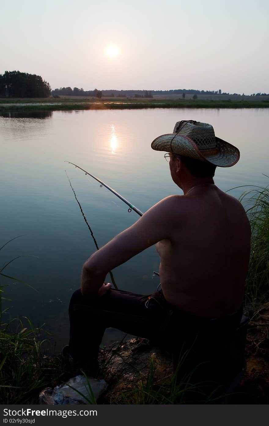 Man fishes in the river on a fishing tackle