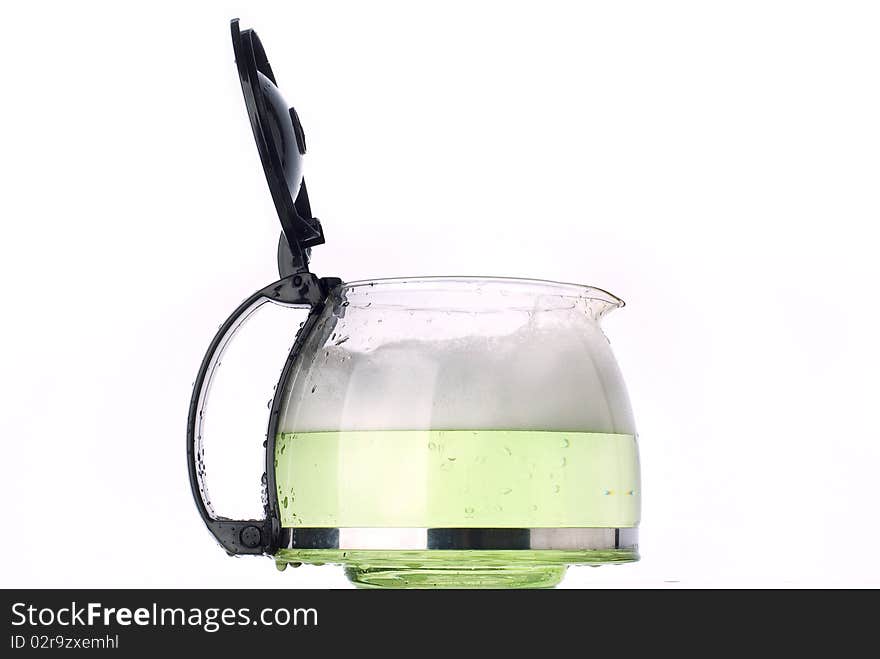 Clear glass container, with green liquid taken on a white background, in studio with 3 lighting set-up