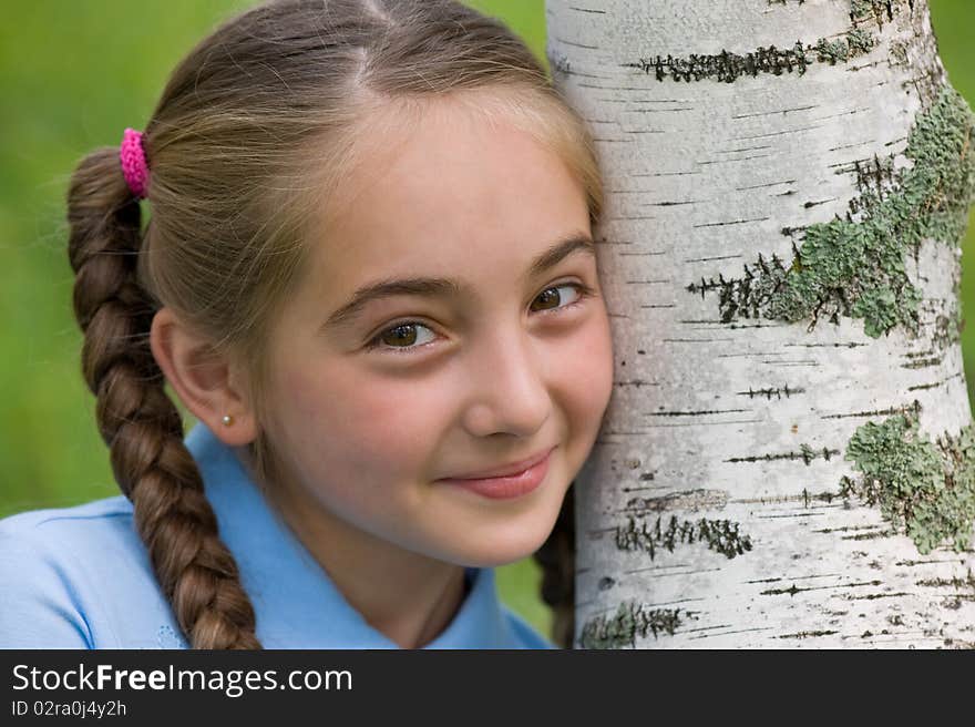 The girl has leaned a head against a birch. The girl has leaned a head against a birch