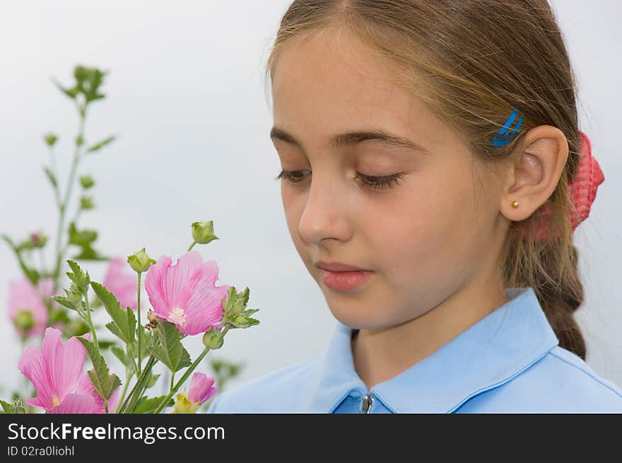 The girl looks at a field flower. The girl looks at a field flower