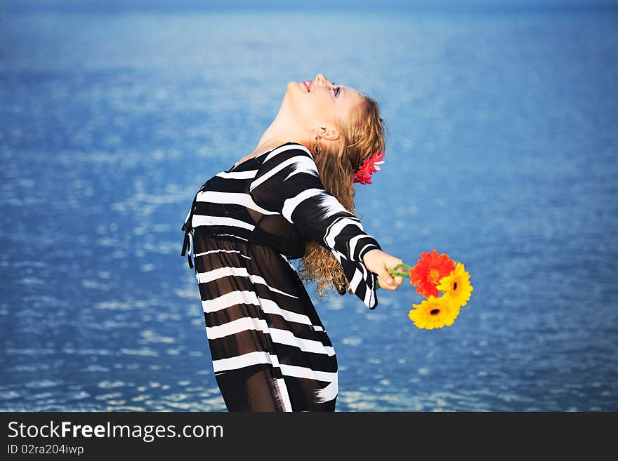 Beautiful woman with flowers in the sea. Beautiful woman with flowers in the sea