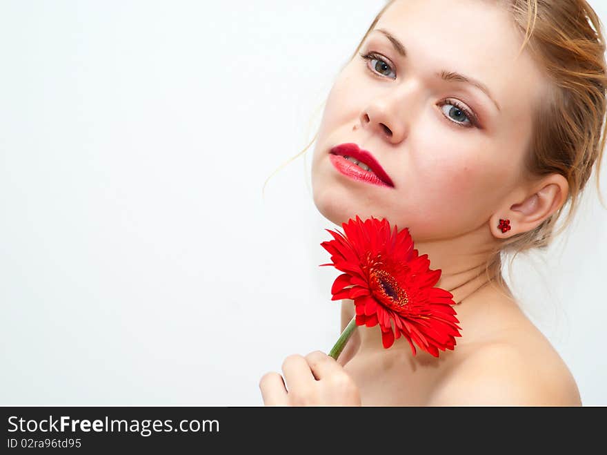 Portrait of the young sensual girl with a red flower. Portrait of the young sensual girl with a red flower