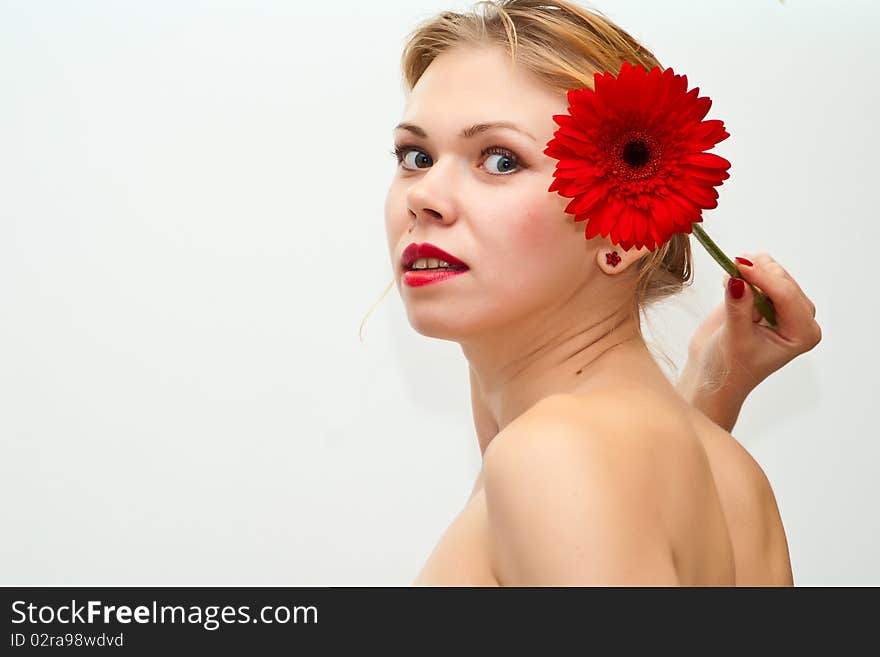 Young sensual girl with a red flower