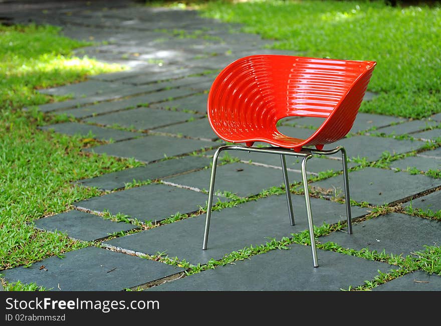 Red chair in green garden