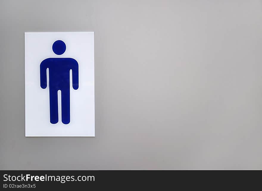 Blue gents public toilet sign on left side of grey background