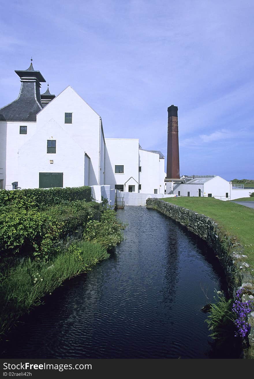 White house at a river with blue sky