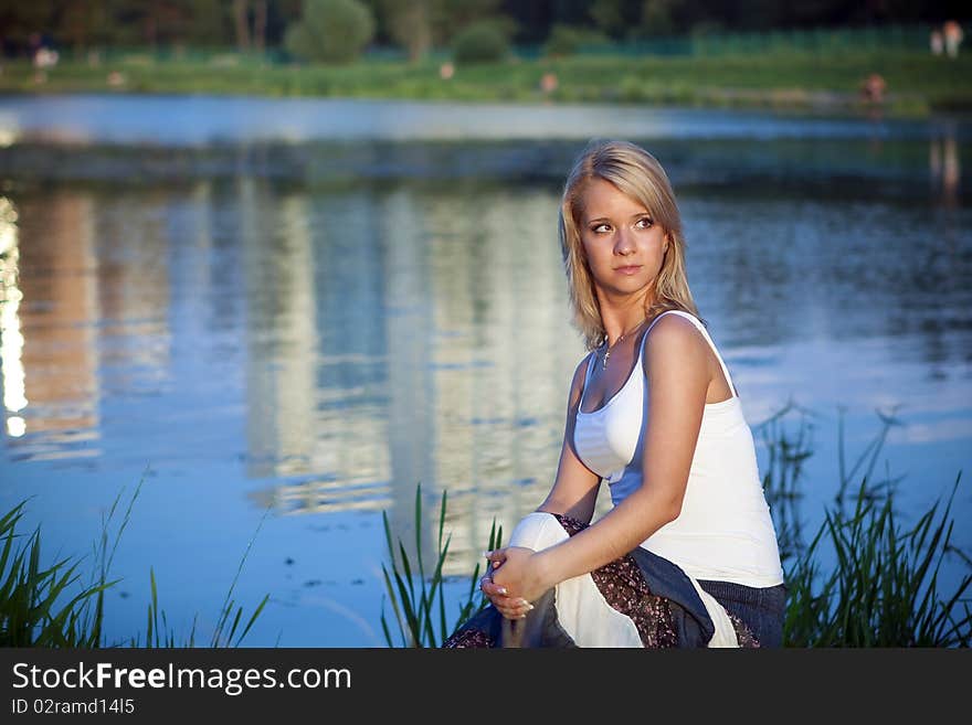 Attractive girl relaxing at the lake. Attractive girl relaxing at the lake