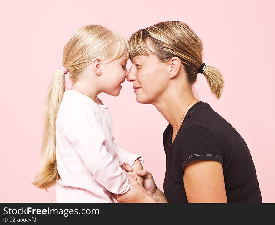 Mother and daughter on pink background