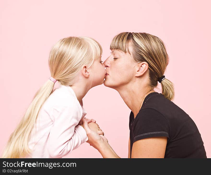 Mother and daughter on pink background