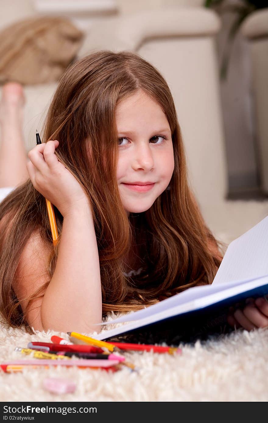 Closeup of cute little girl doing her homework