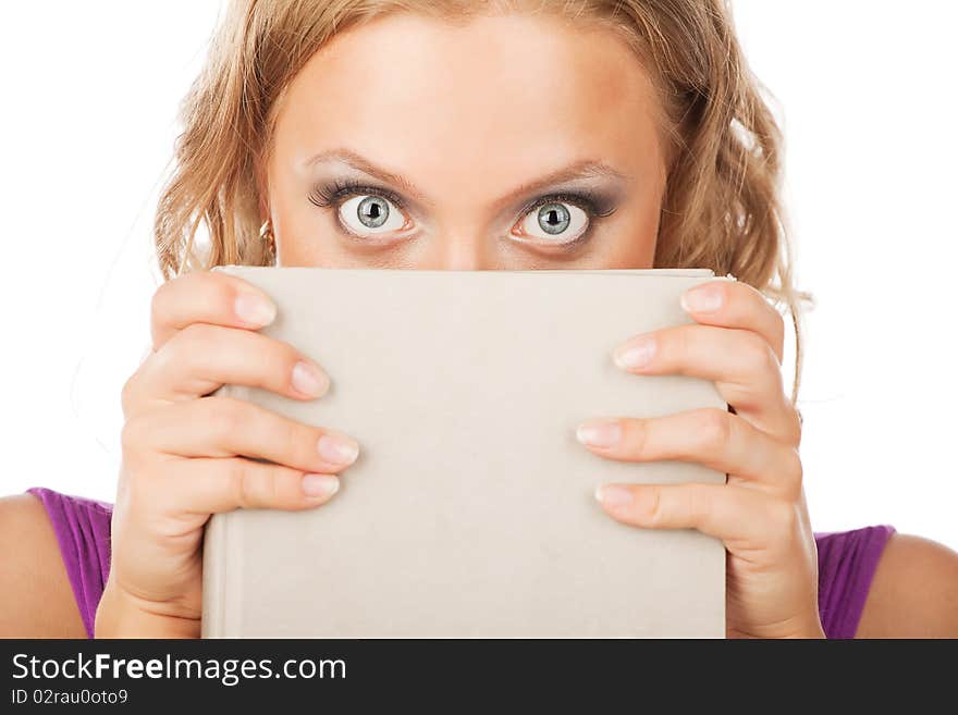 Pretty young woman looks up from her book