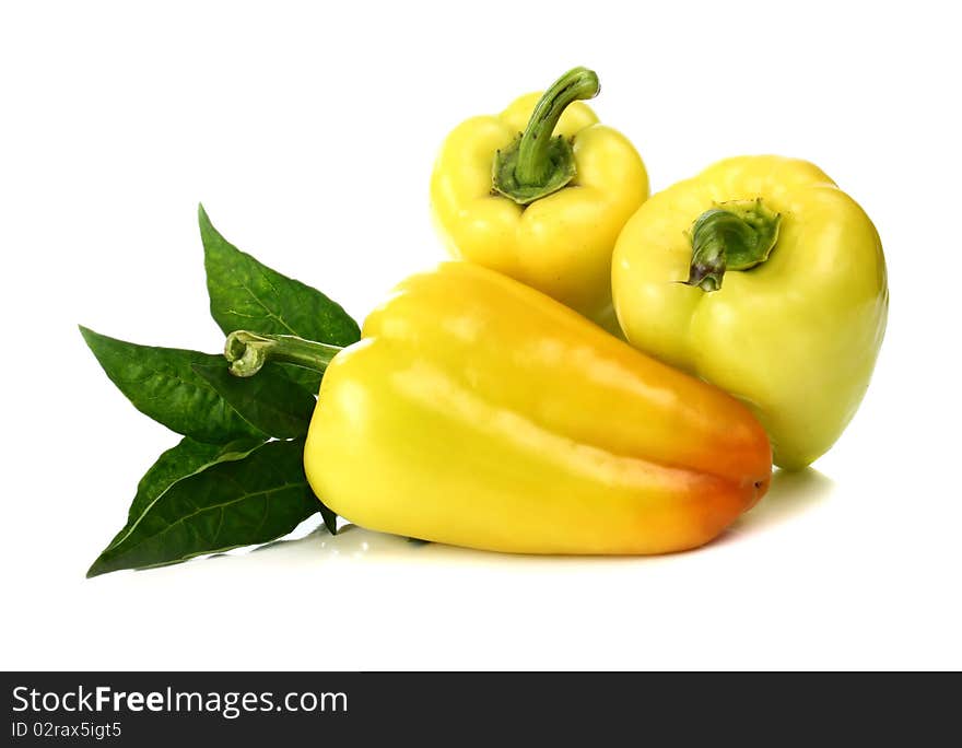 Yellow pepper and green leaf isolated on white background