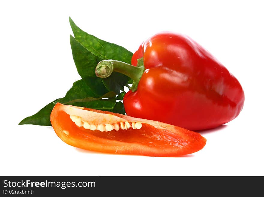 Red pepper and green leaf isolated on white background