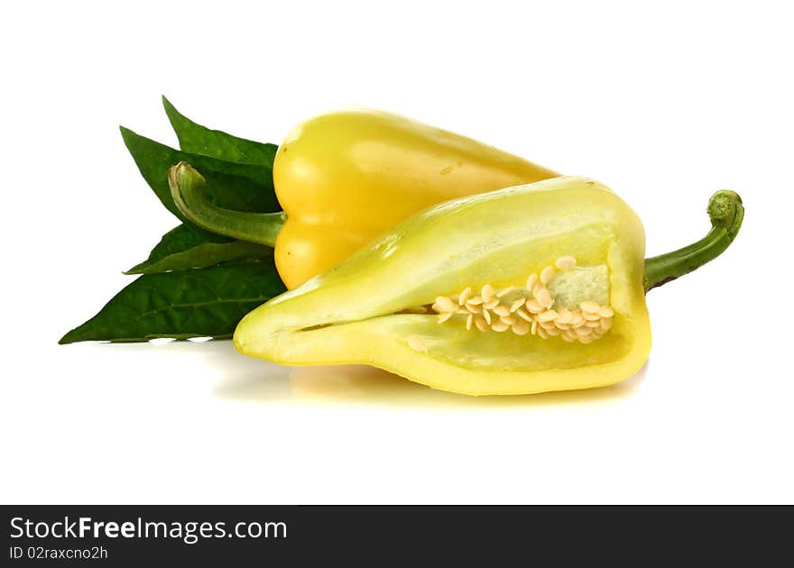 Yellow pepper and green leaf isolated on white background