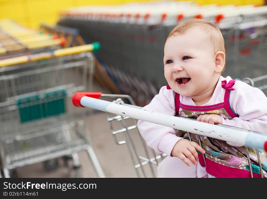 Beautiful baby girl in shopping cart - trolley