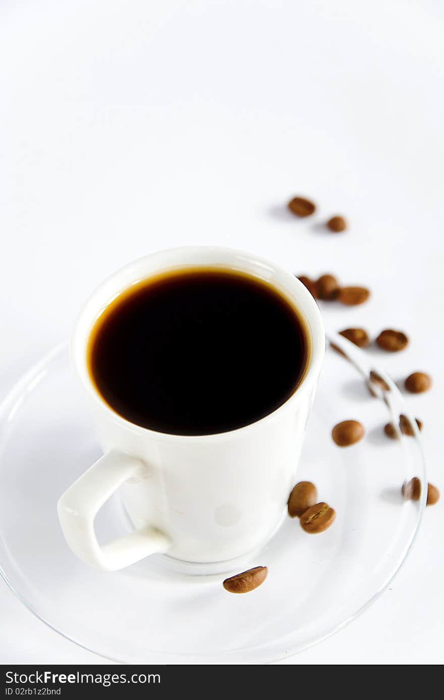 Cup of aromatic coffee with coffe beans