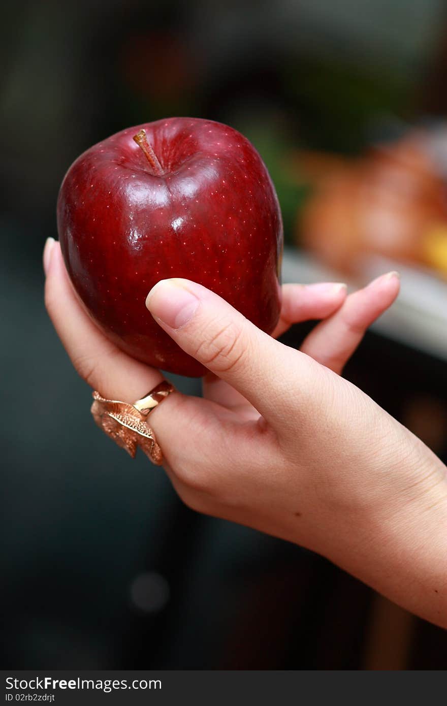 Fresh apple in my sister's hand. Fresh apple in my sister's hand