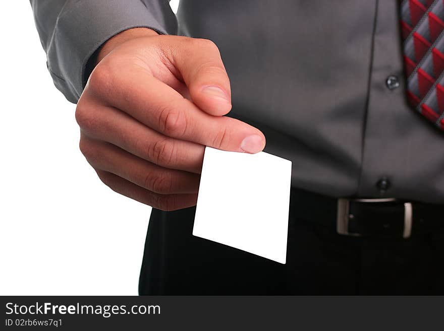 The businessman in a grey shirt and a tie stretches out a business card.