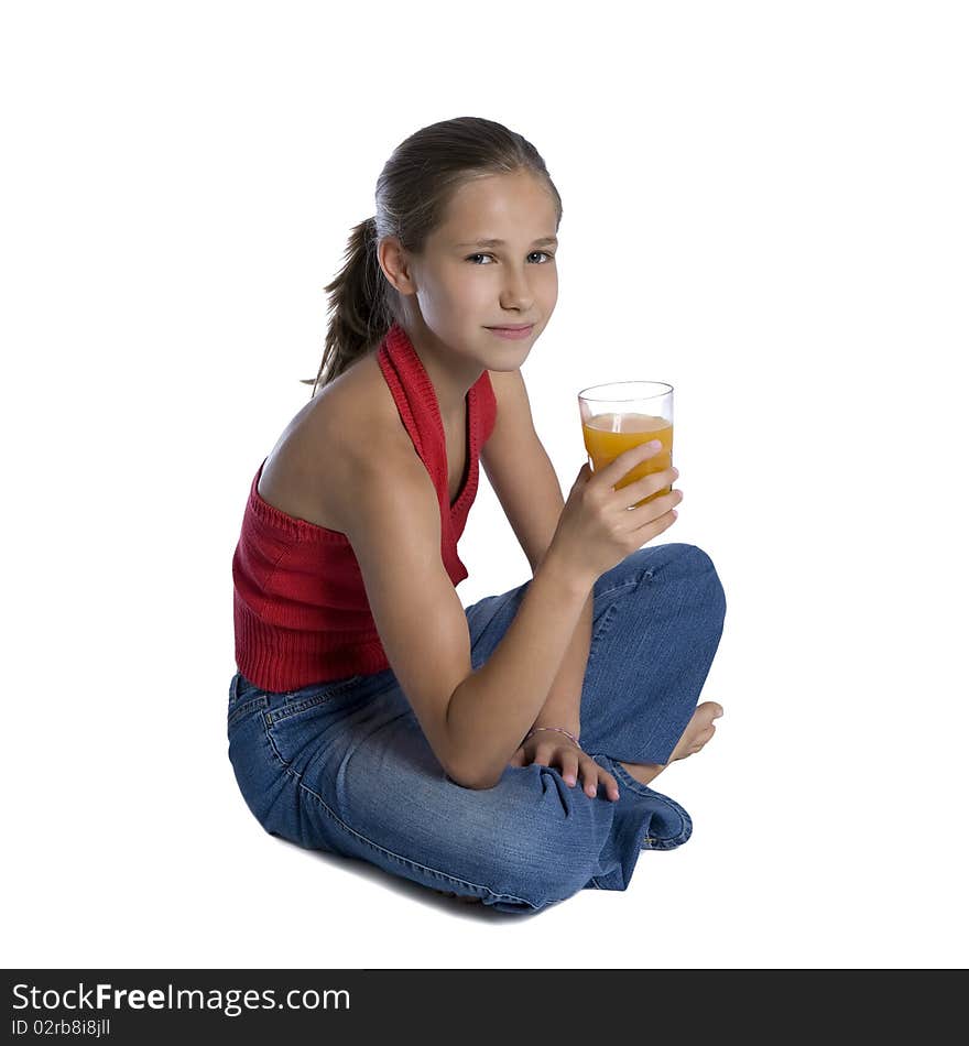 Young Girl Sitting With Glass Of Orange Juice