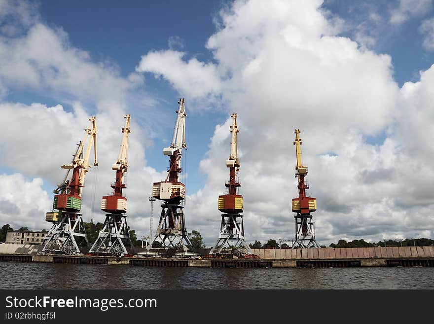 Cranes relaxing in the harbor . Cranes relaxing in the harbor .