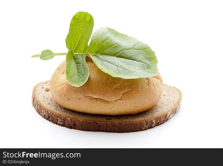 Roll and wheat bread with leaf. Roll and wheat bread with leaf