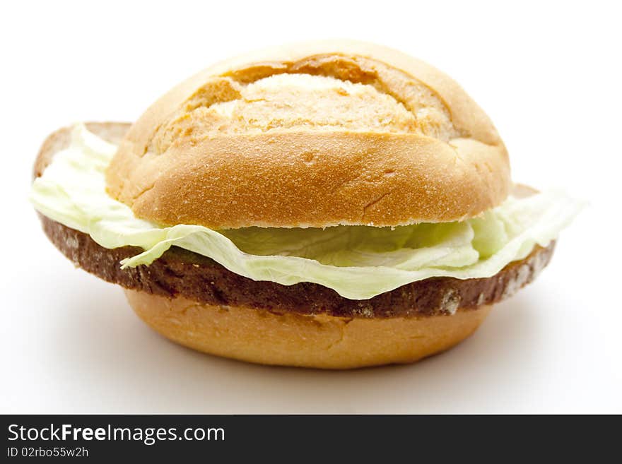 Roll and wheat bread with lettuce leaf