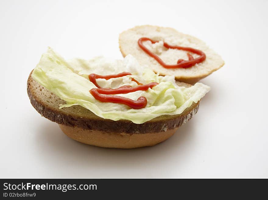 Roll and wheat bread with lettuce leaf. Roll and wheat bread with lettuce leaf