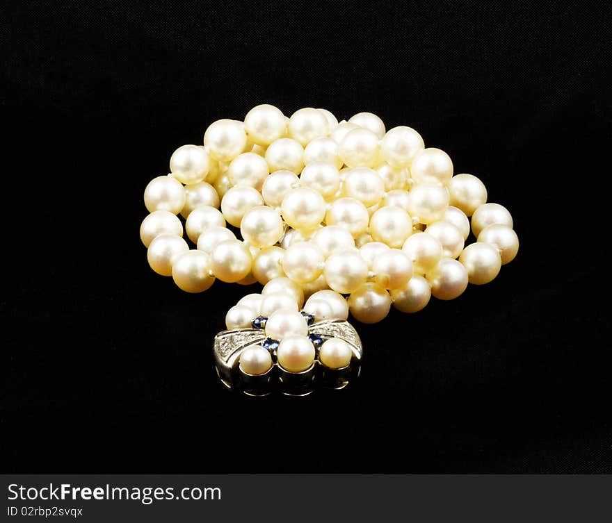 This is an image of pearls with a diamond clasp.