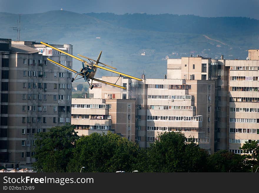 Photo of an Antonov 2 plane, flying between the buildings, spreading mosquito poison. Photo of an Antonov 2 plane, flying between the buildings, spreading mosquito poison